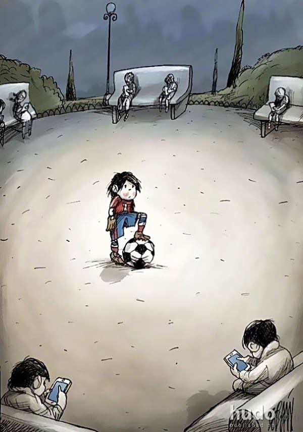 Lone boy with football in the middle of a ground, surrounded by friends engrossed in their cell phones.